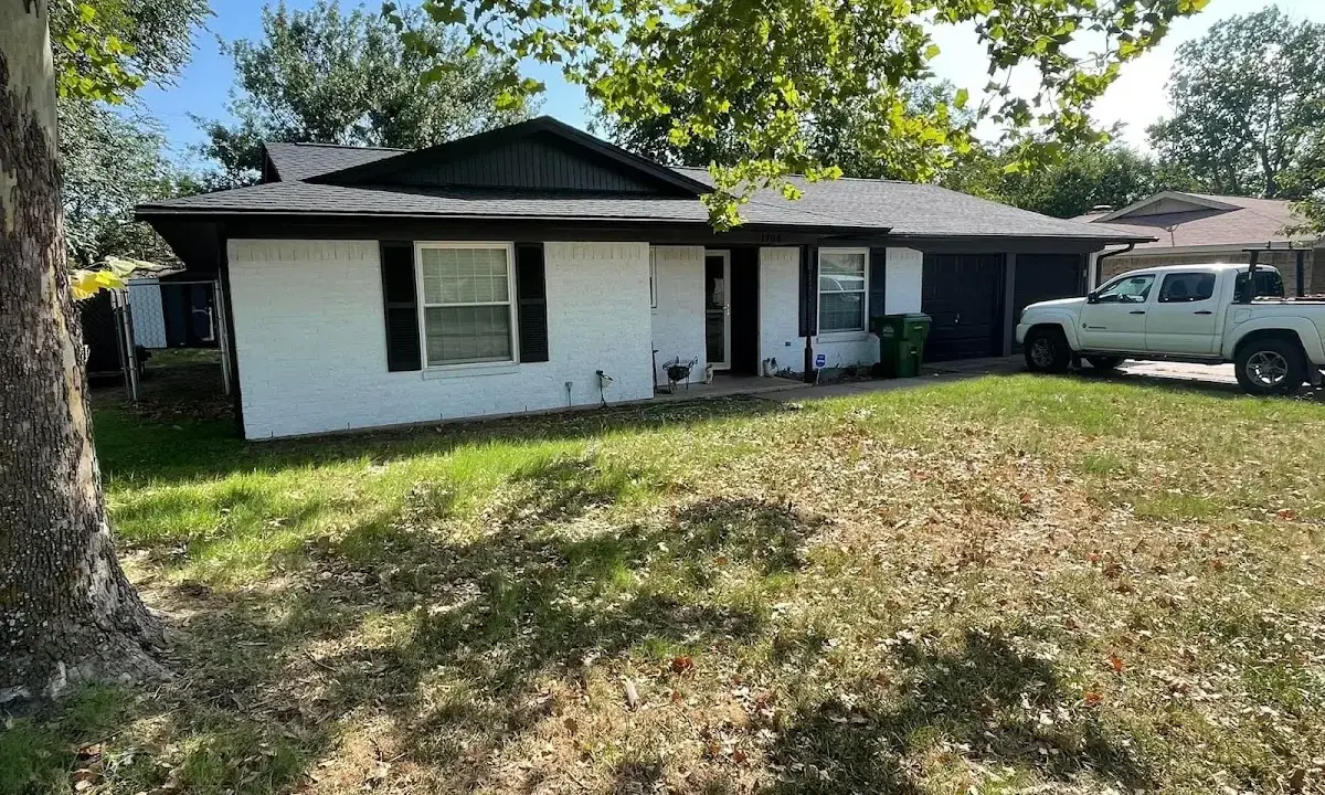 Professional roofing crew working on a residential roof in Tea
